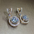 Rose gold heart-shaped earrings with round moissanite center stone and halo diamonds - Rose Gold Led-120
