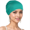 Close-up of turquoise elastic turban cap worn by a model against a white backdrop - One Size / Bright Green