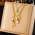Detail of layered gold-plated necklace with snake pendant and emerald green stones - Snake Teardrop Style (N2639)