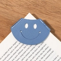 Light blue corner leather bookmark with hollow smiley face and white stitching - Blue