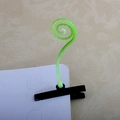 Macro detail of a green sprout hair clip with a black metal duckbill hair fastener - Spiral Grass