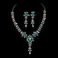 Elegant gold bridal jewelry set with sparkling green and white crystals on black background - Green Rhinestone Gold Plated