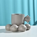 Grey ceramic coffee mug with chunky bubble handle and matching saucer on blue background - Cat Claw Cup & Saucer - Grey