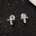 Detail of silver cross clip-on earrings with rectangular cubic zirconia on black background - White Gold Clip-on Huggie Cross