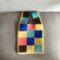 Close-up of knit tote bag with colorful patchwork squares on a soft grey fabric - Yellow Large Checkerboard