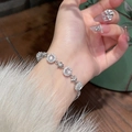 Close-up of silver flower bracelet with zircon stones and chalcedony on a model wrist - Silver