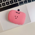 Detail of pink quilted plush doll accessory placed on a laptop showing soft fabric texture - Apple / Pink