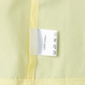 Detail shot of the 100% cotton fabric label on the yellow summer two-piece set - S / Top And Bottom / Yellow