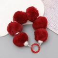 Detail of red plush pom-pom and white pearl beads with a matching red metal ring clasp - Burgundy