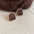 Macro shot of leopard print plush earrings with gold metal frame on fabric background - Trapezoid / Gold Leopard Print