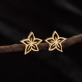 Minimalist gold floral stud earrings in hollow five-petal plum blossom design for women - Gold