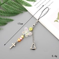 Detail showing a 17cm colorful bow phone charm with smiley face and cross pendant - Smiley Bowknot + Cross Pendant