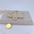 Dettaglio di un ciondolo a bussola dorato con smalto colorato e zircone incastonato - #8 Bussola Colorata