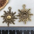 Antique bronze sun charms for jewelry making shown with ruler for size reference - Antique Bronze Sun Pendant (25x28mm)