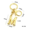 Golden letter M keychain charm with dimensions 35x26mm and polished metal finish - Gold Letter M