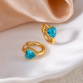 Detail of gold huggie hoop earrings with heart-shaped blue zircon on a white plate - Heart Zirconia / Blue