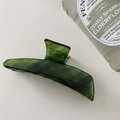 Detail of green marble acetate hair claw clip showing glossy texture and elegant patterns - Oblique Straight