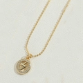 Macro detail of gold lightning bolt pendant with sparkling white zircon inlay necklace - Flash