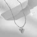 Silver snake chain necklace with 3D heart pendant on white geometric stone - Bead Chain Heart Necklace / Steel