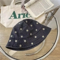 Retro black denim bucket hat with white daisy embroidery on a modern glass side table - Adult Adjustable / Black