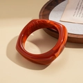 Detailed view of caramel resin geometric bracelet showing wood grain marble texture - Orange Marbled Square Style