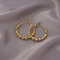 Chic gold-plated hoop earrings with multifaceted metal beads on soft purple silk fabric - Faceted Bead Hoop / E-053---Gold