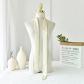 Detail of elegant ivory satin skinny scarf tied as a bow on a white ceramic vase - 190*5cm / Cream