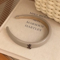 Minimalist beige faux leather headband with a tortoiseshell bow accent on a book - Khaki