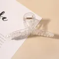 Detalle de una pinza para el pelo transparente irisada con muelle de metal dorado - Pinza Cruzada Pequeña Transparente AB