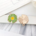 Detail of green and yellow enamel daisy flower charms with textured golden metal backings - Single Sided Sunflower