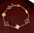 Elegant gold clover bracelet with five flower pendants on dark red textured background - Four-Leaf Clover / Gold