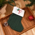 Green cable-knit Christmas stocking with white cuff and red embroidered letter F - Letter F