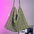 Detail of olive green canvas tote bag with floral pattern and stitched logo tag - Green Jasmine