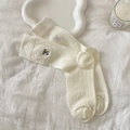 Off-white ribbed mid-calf socks with black embroidery logo on soft white fabric background - Beige