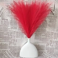 Artificial red pampas grass bouquet in a white ceramic vase for home decor - Red