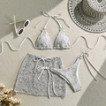 Flat lay of three-piece mesh bikini set with sarong skirt and summer vacation accessories - S / White