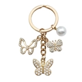 Elegant gold keychain with butterfly charms, pearls and diamonds on white background - Butterfly Pearl (ER703)