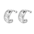 Detail view of S925 sterling silver hoop earrings with diamond-set star motifs - Star Embossed Huggie / Silver