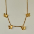 Detailed view of the gold butterfly necklace with intricate engraved texture on pendants - 41+5cm Necklace
