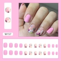 Macro detail of matte pink press-on nails with daisy floral patterns and solid colors - Matte Small Flower (W157)