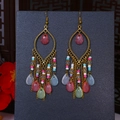 Detailed shot of Bohemian tassel earrings with colorful beads and waterdrop charms - Pink Multicolor