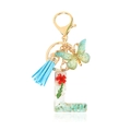 Letter L crystal resin keychain with blue tassel, butterfly charm, and dried red flowers - Letter L