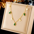 Detailed view of a gold chain necklace with butterfly charms and green gemstones in a box - Gold (N2426)