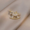 Golden unicorn rocking horse brooch with white crystals on champagne silk background - Unicorn Rocking Horse (90246G)