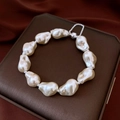 Detailed view of Baroque pearl bracelet with silver chain on premium jewelry box - White-Silver
