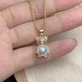 Close-up of golden bear pendant with zircon head and large pearl belly on a chain - Large Pearl Belly Style (F)