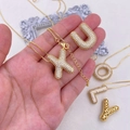 Detail shot of a chunky gold letter X pendant with zircon pavé on a thin chain necklace - Letter A / Letter A / Gold
