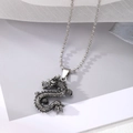 Detailed view of vintage silver dragon pendant with intricate punk style engravings - Style 10: Small Dragon