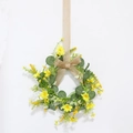 Easter floral wreath with yellow daisies, green leaves, and burlap bow on white background - Yellow Daisy Eucalyptus Wreath with Linen Bow