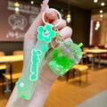 Close-up of green Sakura cherry blossom liquid oil keychain with silicone wristband - Cherry Blossom Rope [green] Glowing Dried Flower Iceberg Cup